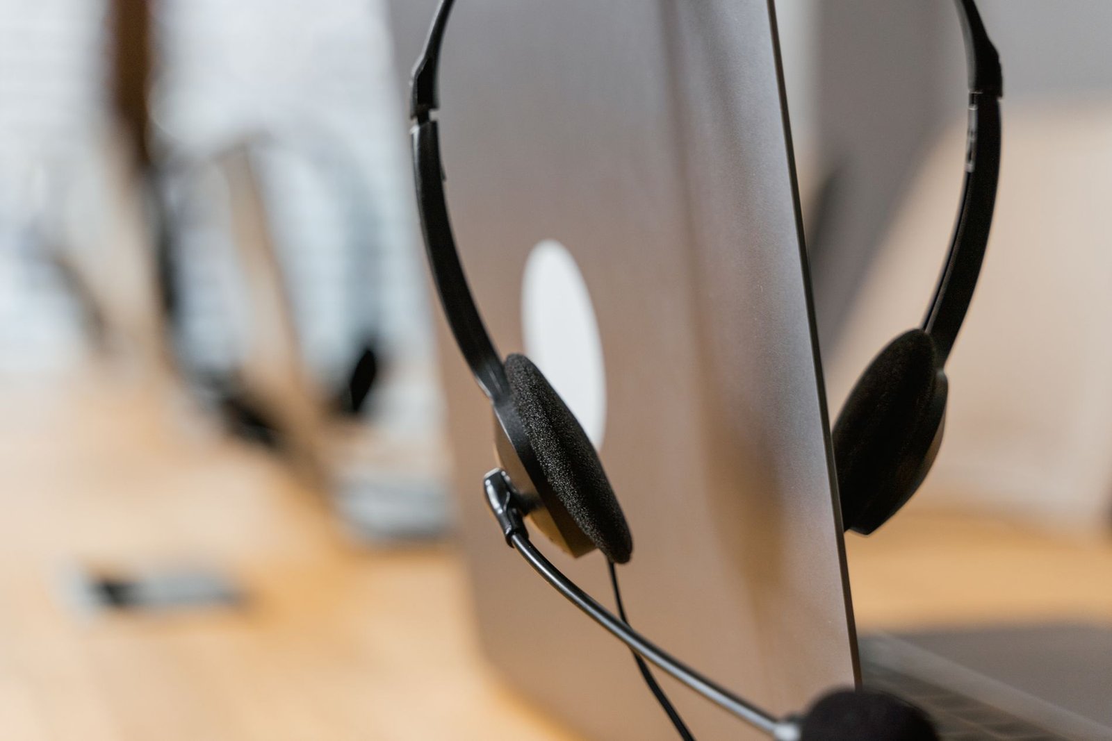 Support headset on a desk beside a laptop at the SmartPips help desk