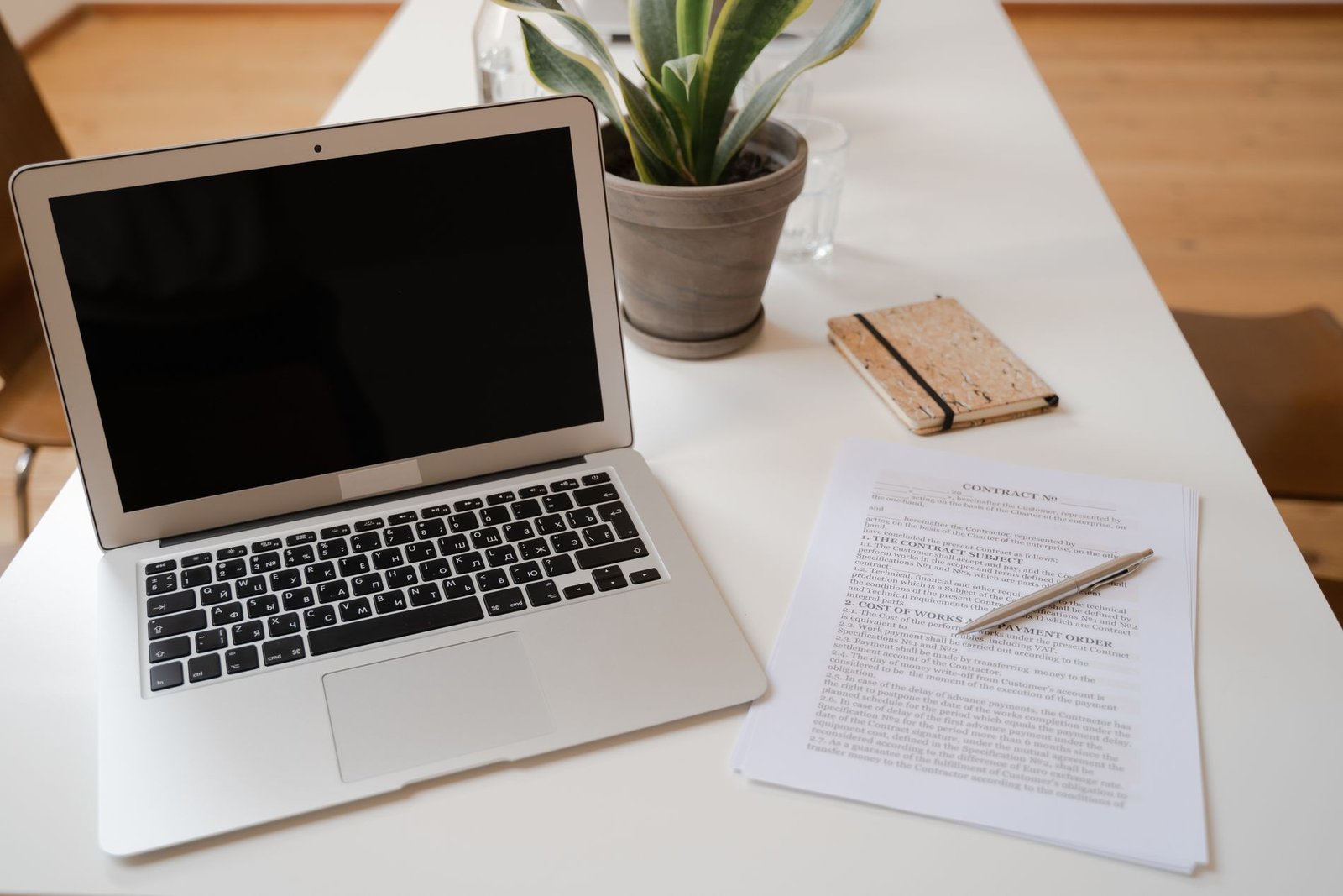Printed agreement and laptop on a desk — SmartPips legal documents