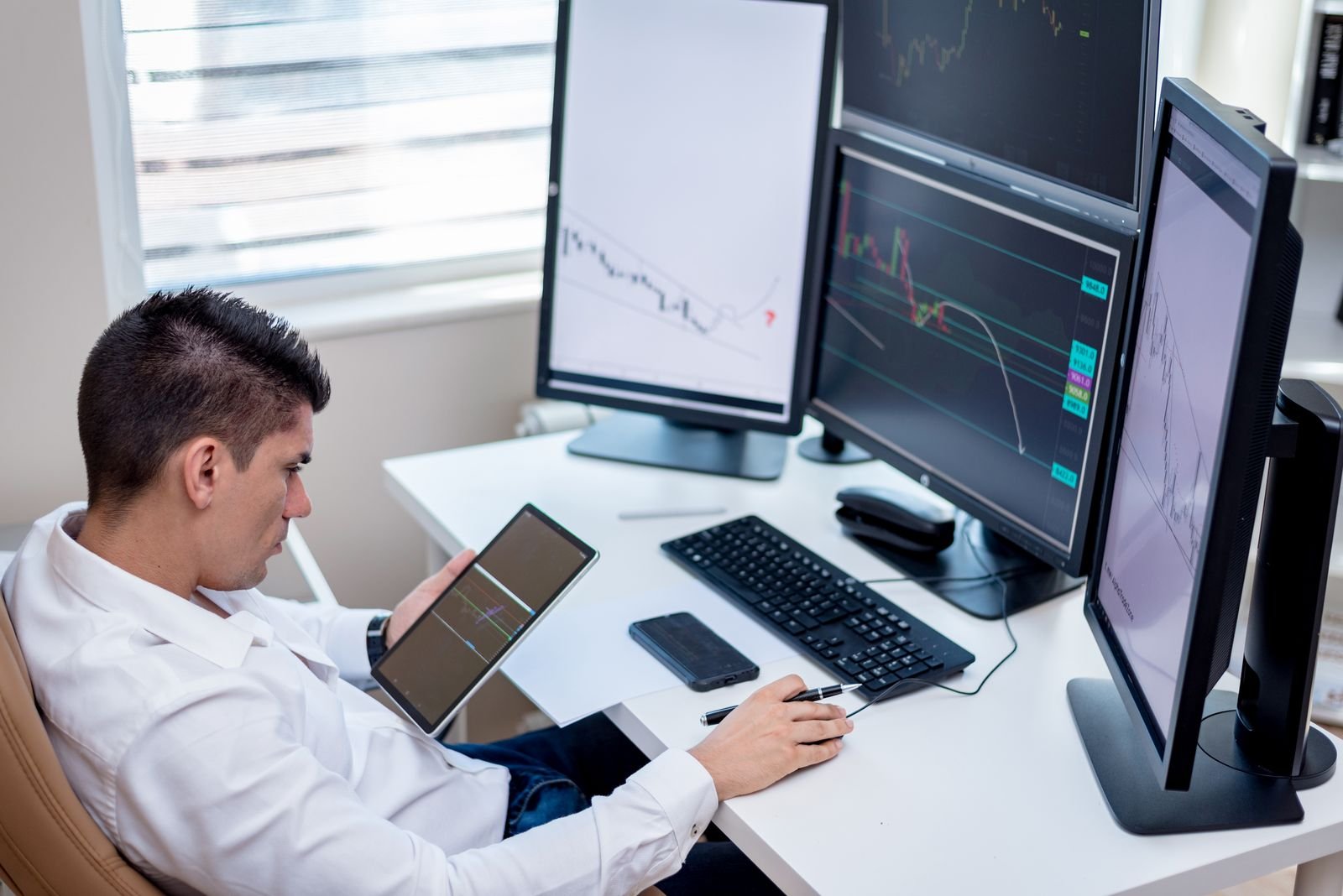 Market analyst comparing forex charts across monitors during the London session