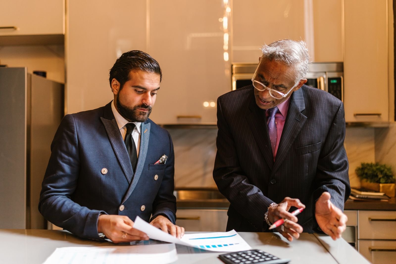 Two portfolio managers working through a weekly trading strategy review